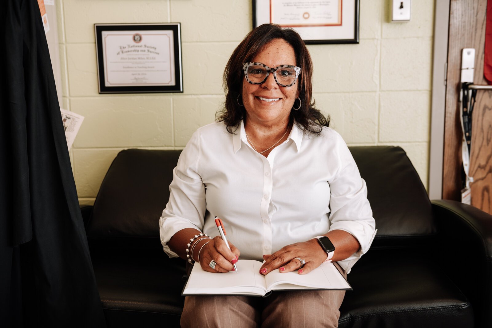 Alice Jordan-Miles, Director of Bien Estar Sin Fronteras (Wellness Without Borders) takes notes in her office at Purdue Fort Wayne.