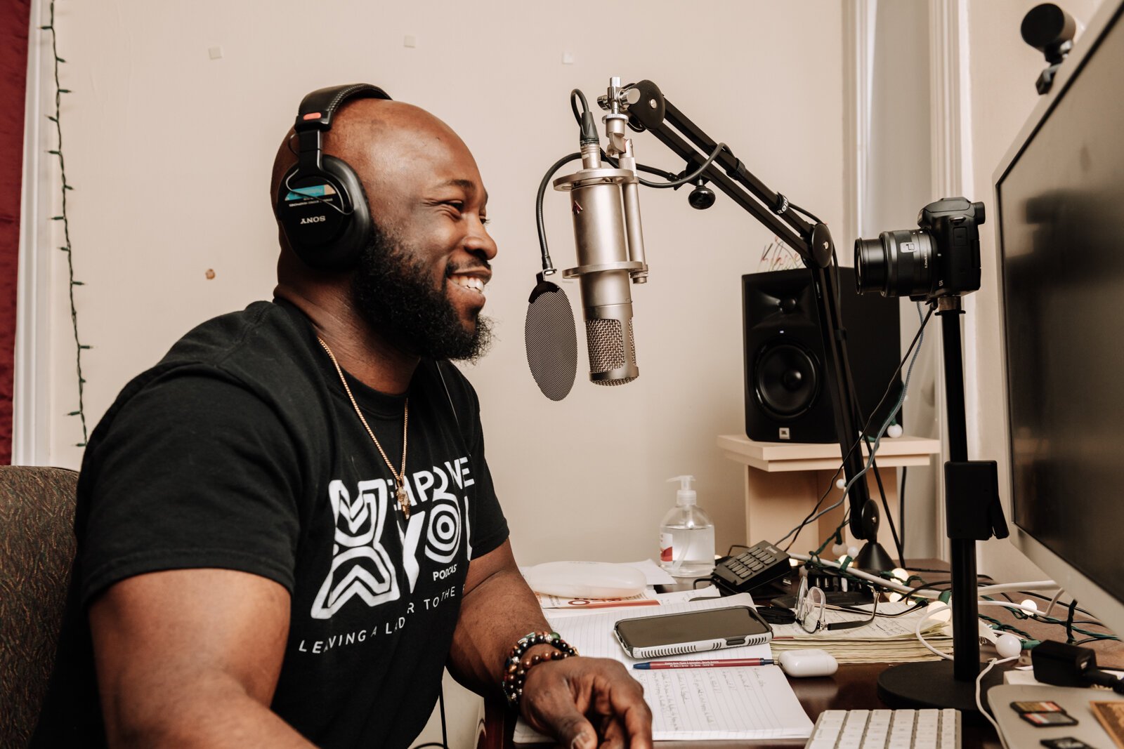 Kibwe Cooper, the host of 'Empower You Podcast', works on a podcast in his studio at home.