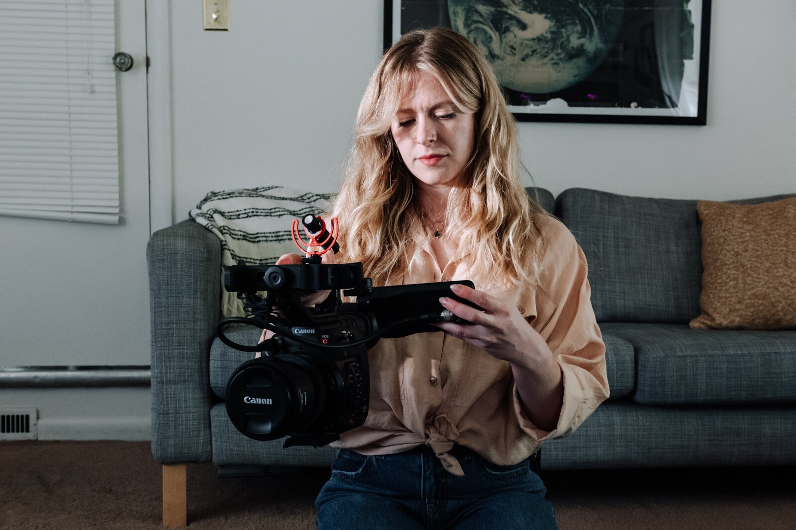 Jordan Bishop, an employee at Bowen Center, works on collecting gear for her next photoshoot for Bowen Center, at her home.