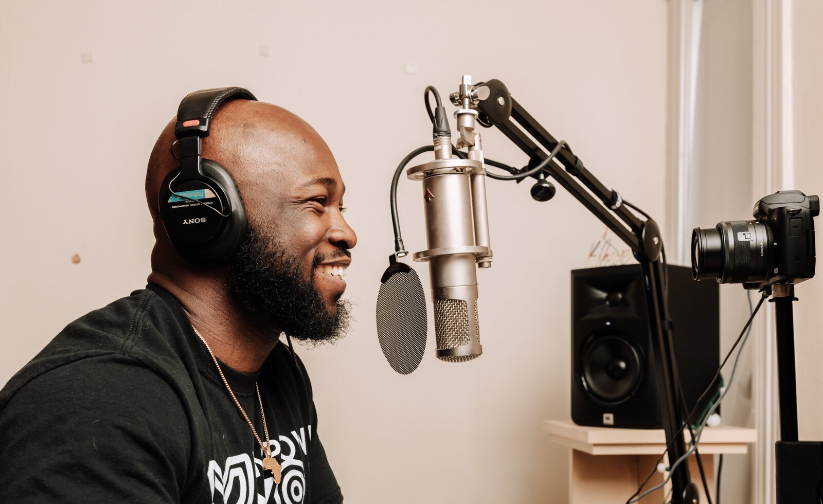 Kibwe Cooper, the host of 'Empower You Podcast', works on a podcast in his studio at home.