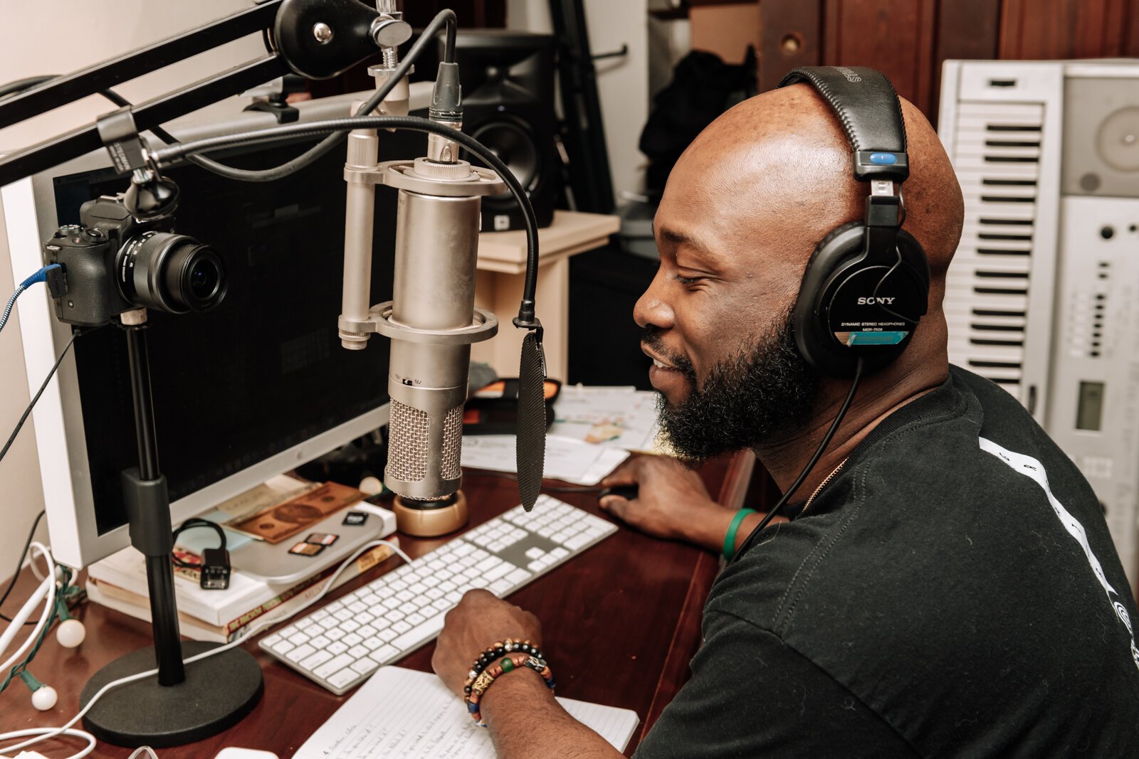 Kibwe Cooper, the host of 'Empower You Podcast', works on a podcast in his studio at home.