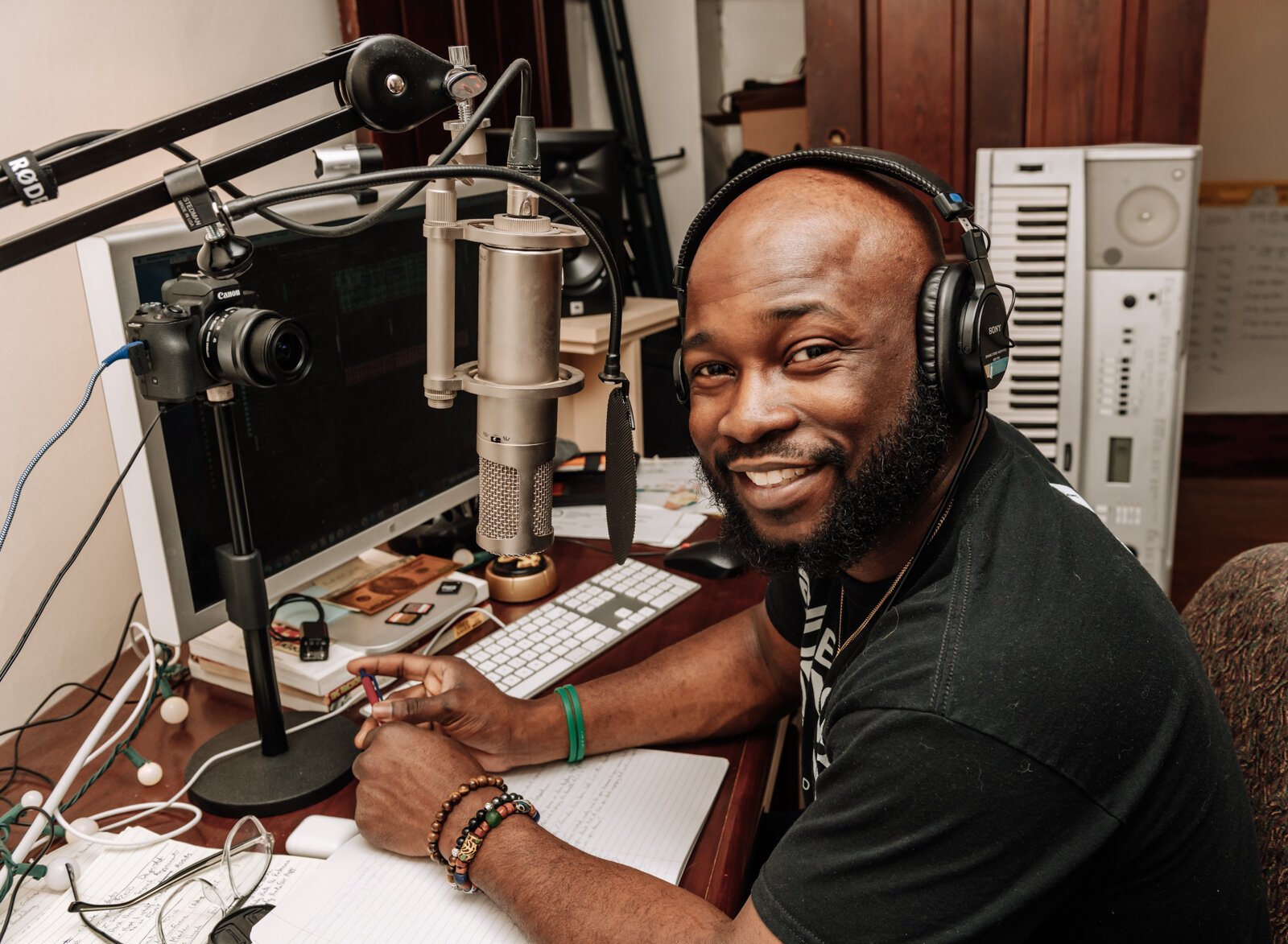 Kibwe Cooper, the host of 'Empower You Podcast', works on a podcast in his studio at home.