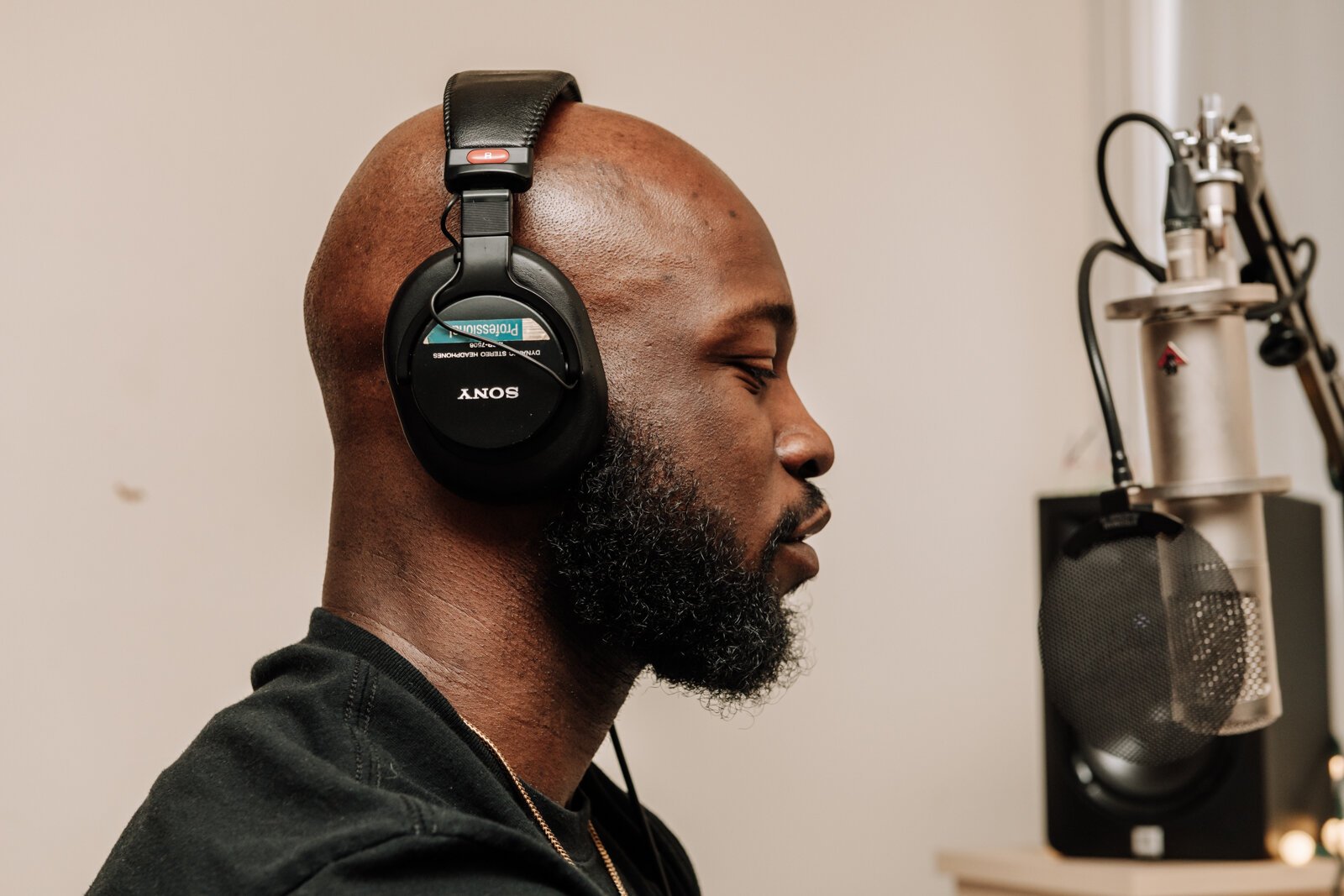 Kibwe Cooper, the host of 'Empower You Podcast', works on a podcast in his studio at home.