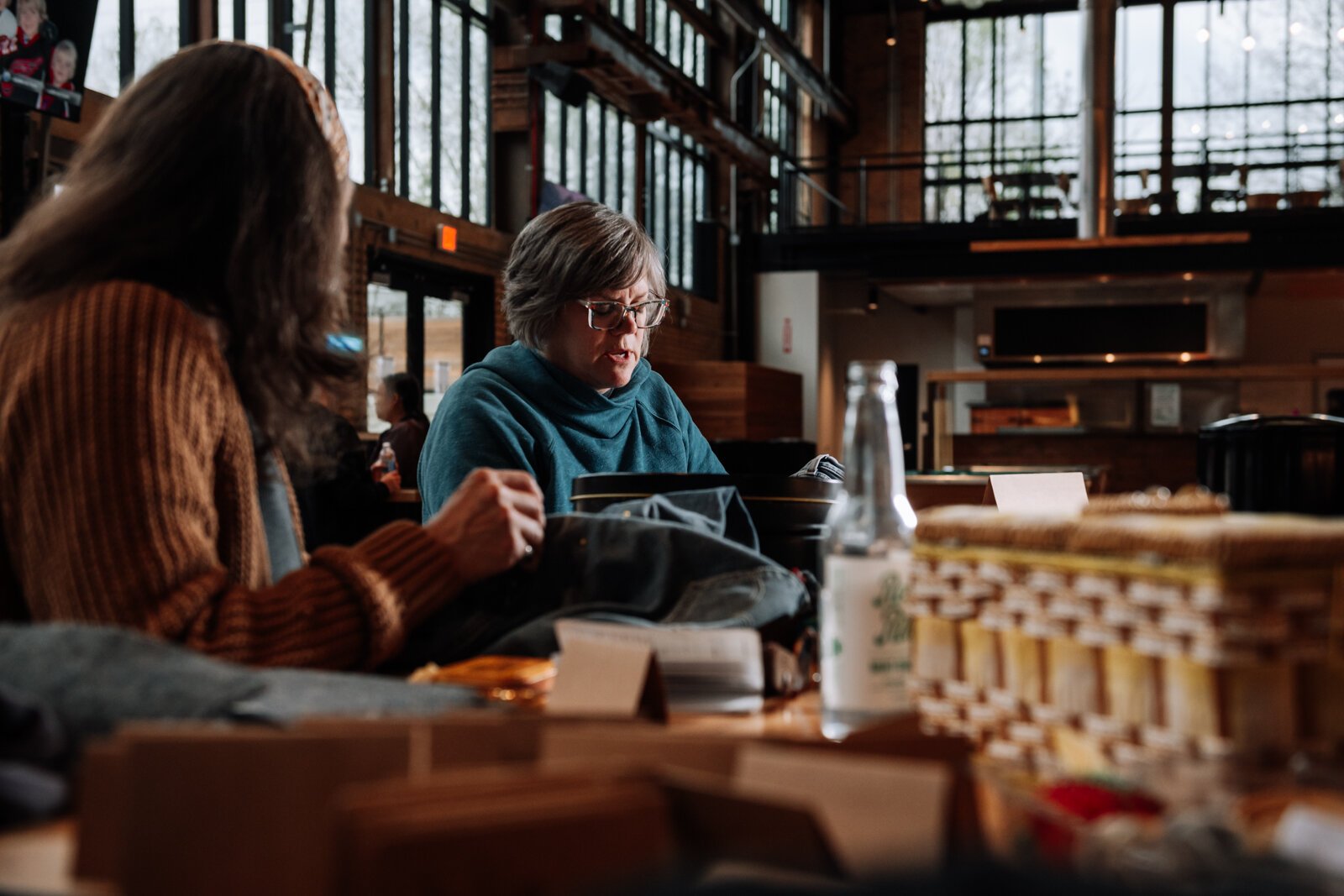 Megan Burton talks mending techniques with Mia Morris.