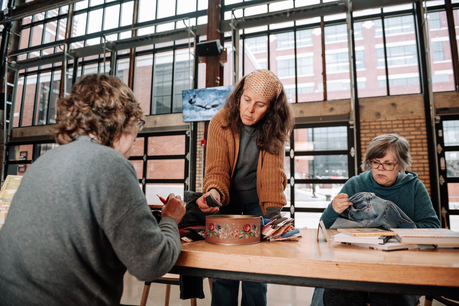From left: Jennie Renner, Megan Burton, and Mia Morris work on mending projects.