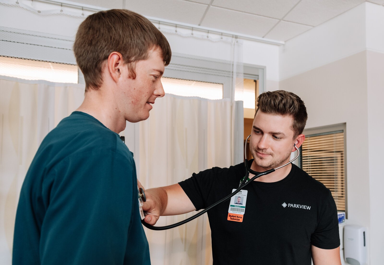 Jayce Colclasure, Student Nurse Apprentice, right, practices an assessment with his mentor Colin Fassold, Registered Nurse at Parkview Regional Medical Center.