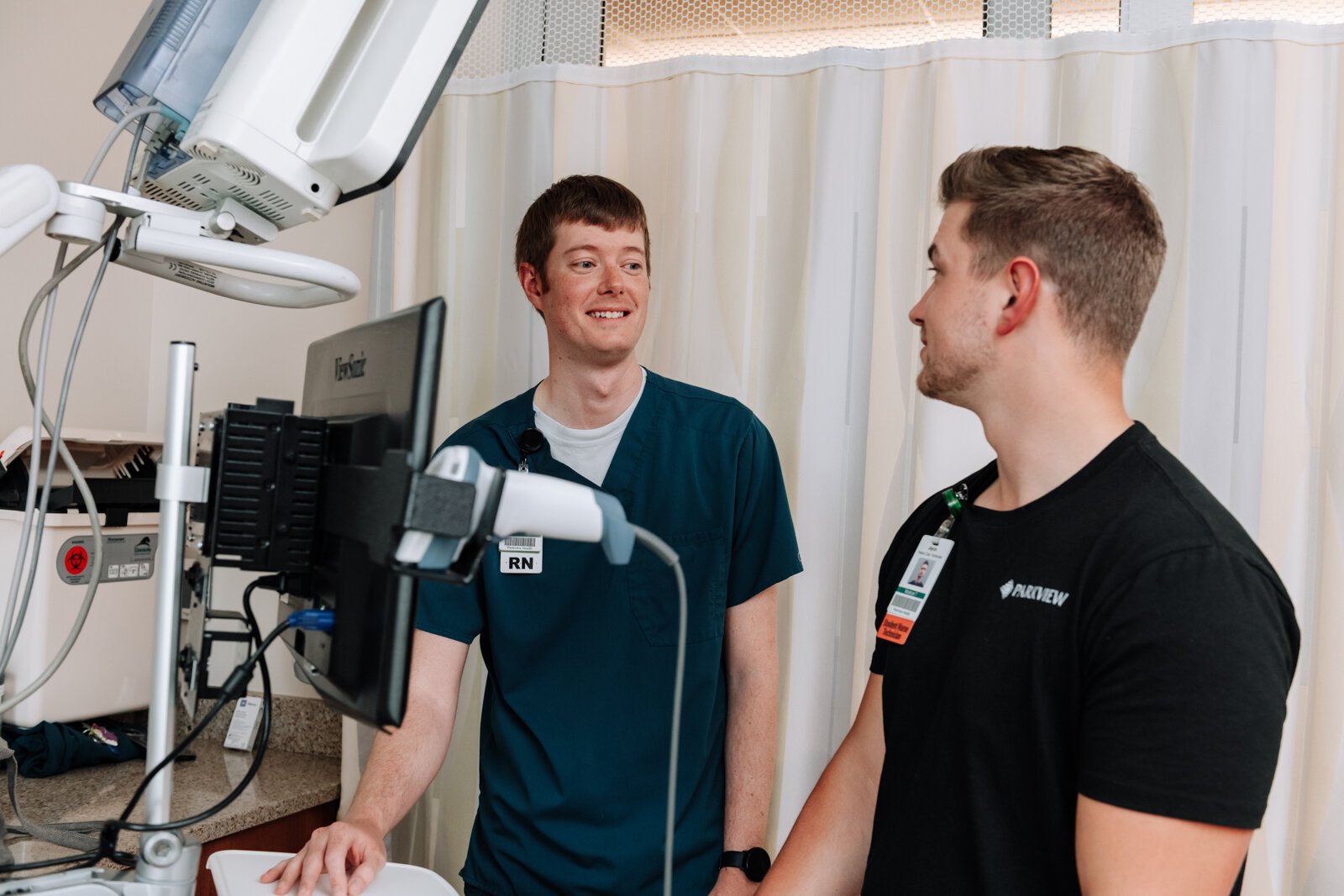 Jayce Colclasure, Student Nurse Apprentice, right, works on charting with his mentor Colin Fassold, Registered Nurse at Parkview Regional Medical Center.