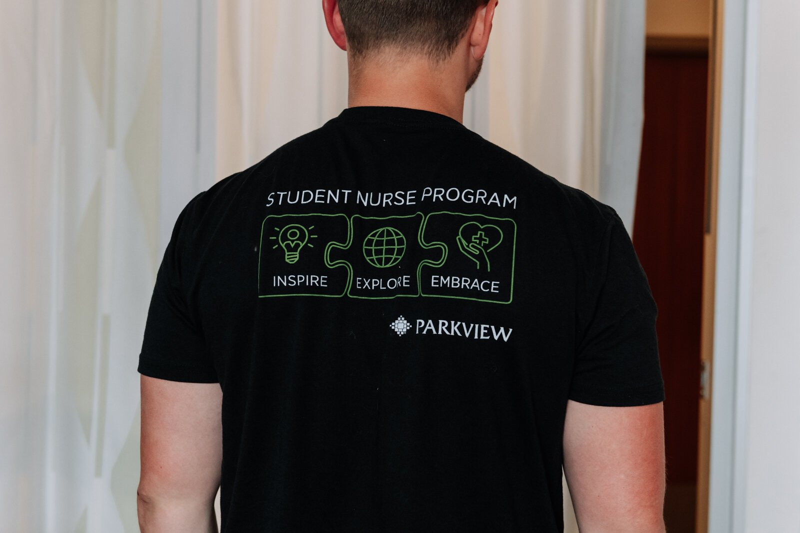 Jayce Colclasure, Student Nurse Apprentice, shows off his shirt at Parkview Regional Medical Center.