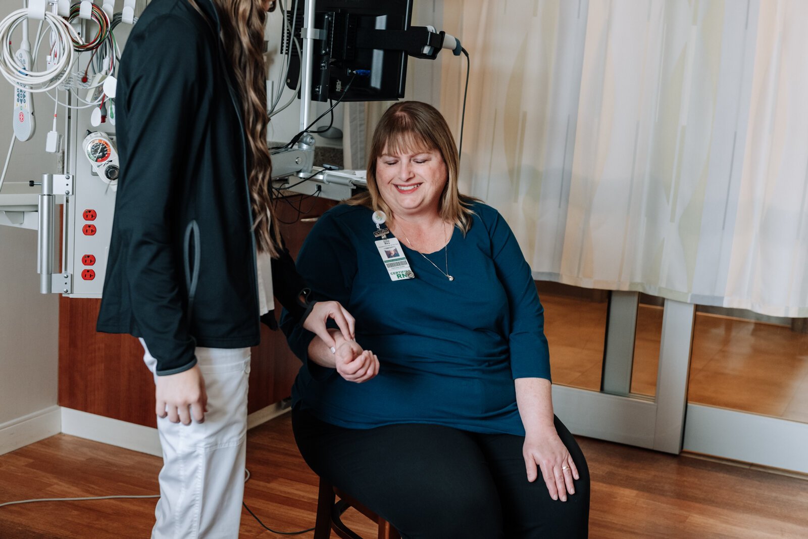 Bryn Benzing, Student Nurse Assistant, checks the pulse of Mary Hunt, Supervisor for the Student Nurse Program at Parkview Regional Medical Center.