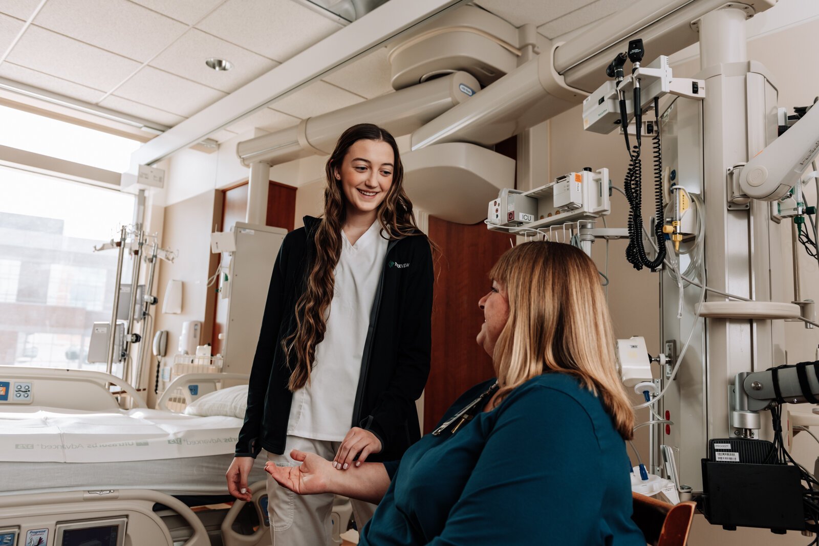 Bryn Benzing, Student Nurse Assistant, checks the pulse of Mary Hunt, Supervisor for the Student Nurse Program at Parkview Regional Medical Center.