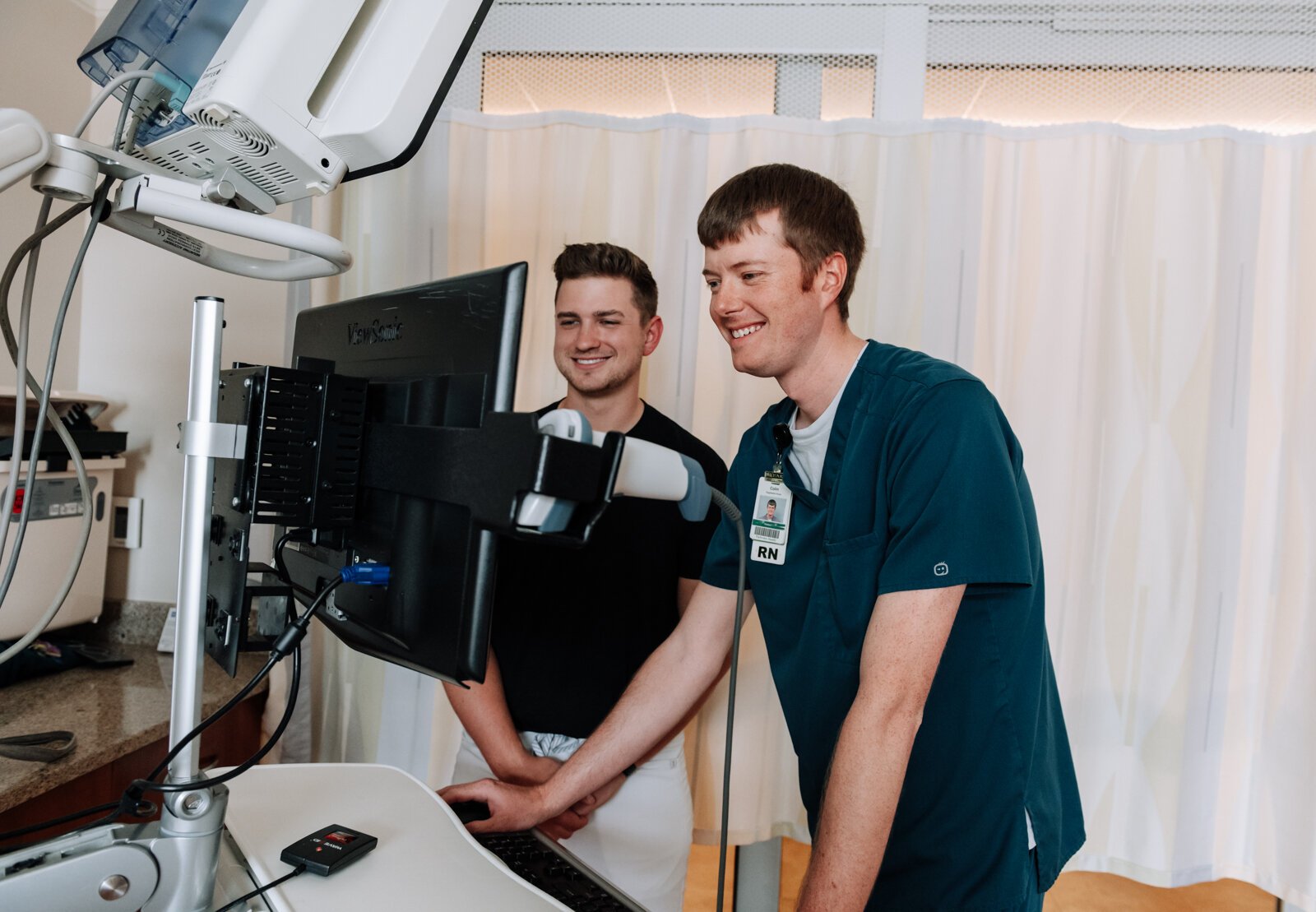 Jayce Colclasure, Student Nurse Apprentice, left, works on charting with his mentor Colin Fassold, Registered Nurse at Parkview Regional Medical Center.