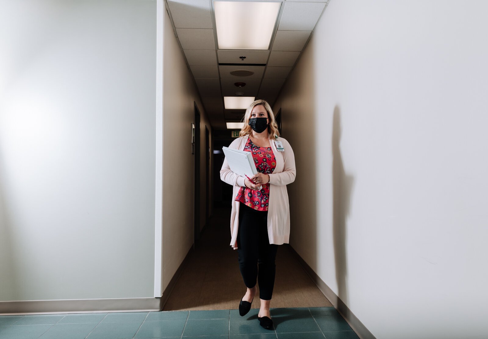 Caroline Braun, Clinical Programs Manager for Parkview Behavioral Health Institute, walks the halls at Park Center, 2710 Lake Ave.