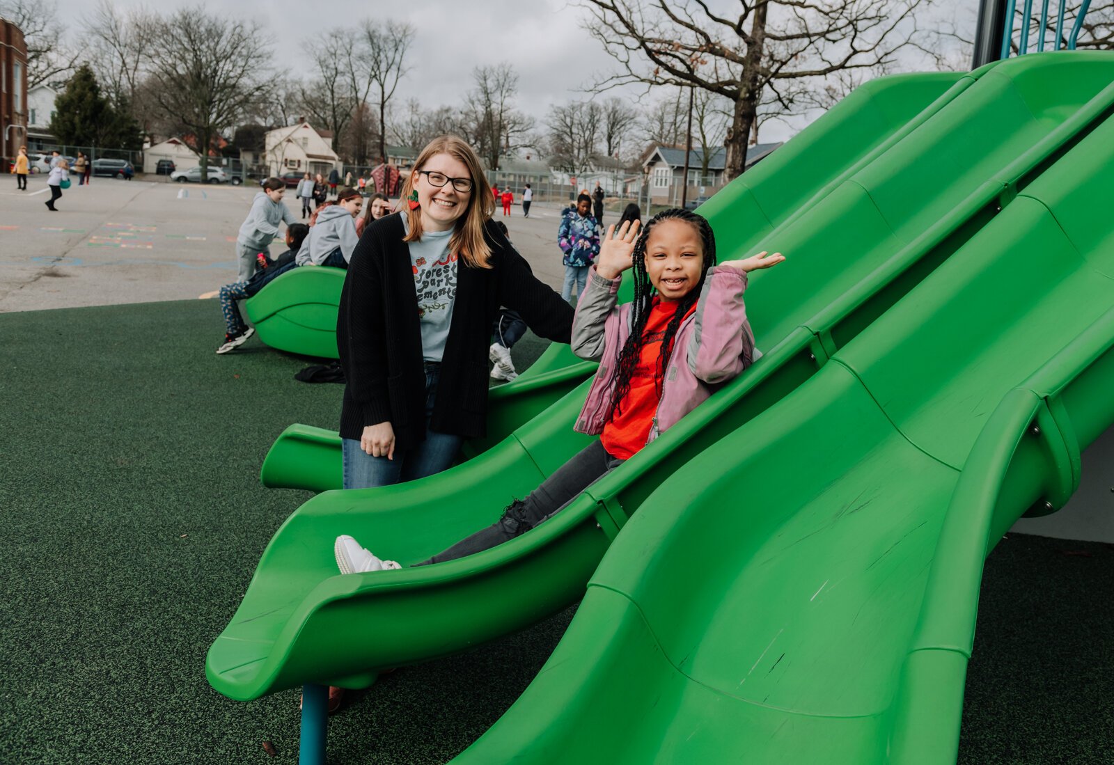 Kamyra Smith slides on the playground as Leitia McHugh looks on during the fourth grade recess at Forest Park Elementary School.