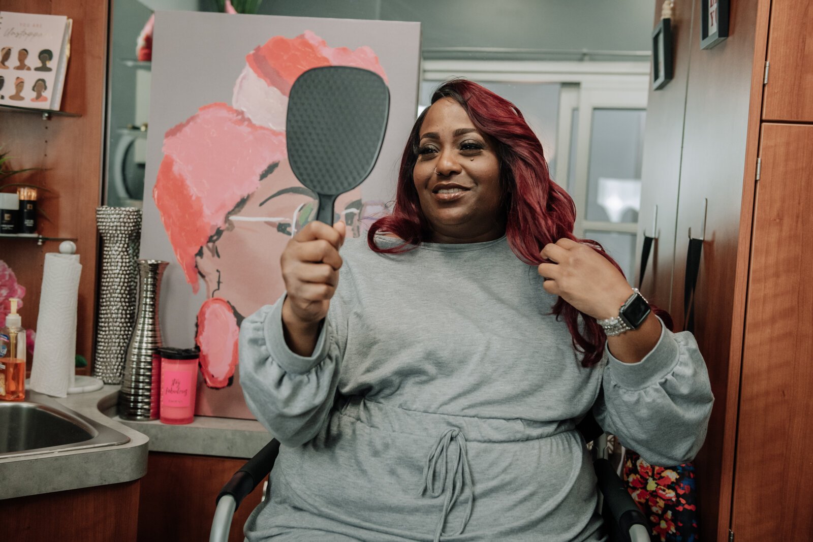 Client Toya T. checks out the finished work by Rohli Booker with Aza Image Beauty & Brow Studio after a brow wax and fill eyebrow service.