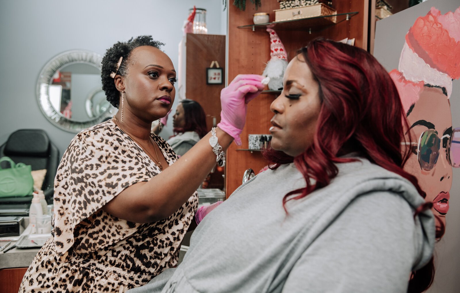 Rohli Booker with Aza Image Beauty & Brow Studio does a brow wax and fill eyebrow service for Toya T. in her studio.