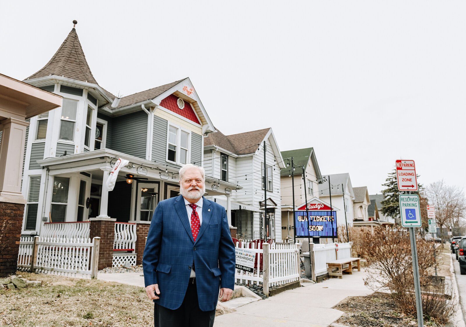 Portrait of Rudy Mahara in front of Rudy's Cigar Shop.