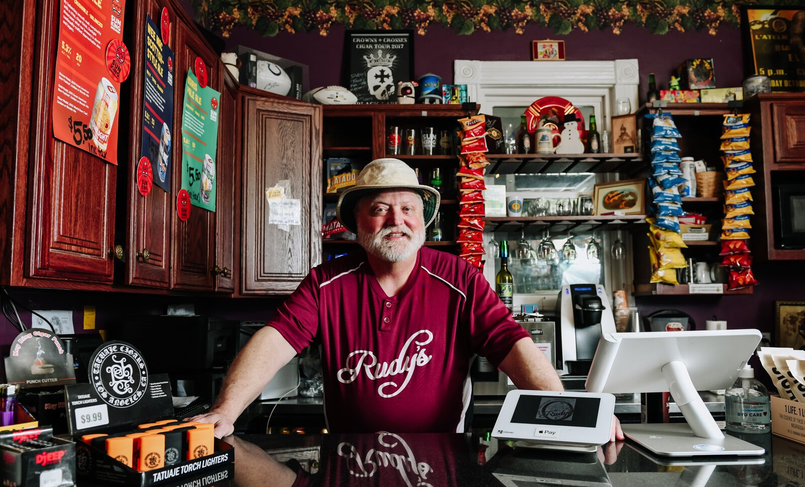 Rudy Mahara behind the counter at Rudy's Cigar Shop.