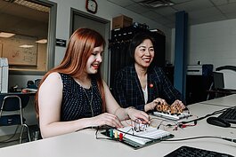Indiana Tech student Alexandra Forsythe, left, and Dr. Ying Shang, Dean of the College of Engineering and School of Computer Sciences work together on operational amplifier functions in the Zollner Engineering Center.