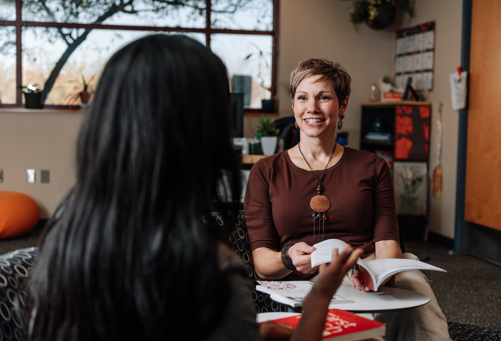 Leslee Hill, right, Program Director talks with Rosalina Perez, Program Manager during a meeting together at WEOC Women's Business Center at the Northeast Indiana Innovation Center.