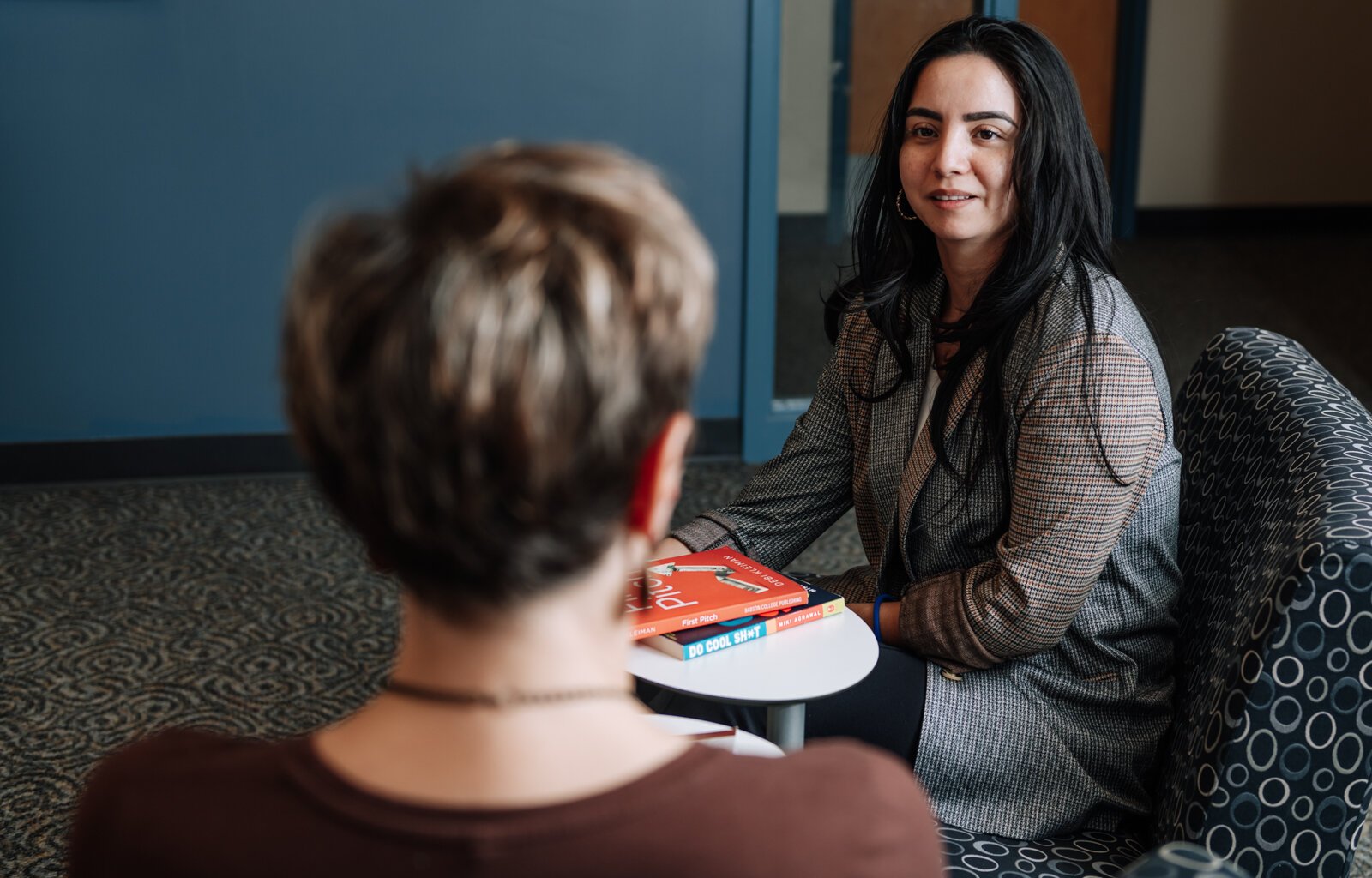 Rosalina Perez, Program Manager, right, talks with Leslee Hill, left, Program Director during a meeting together at WEOC Women's Business Center at the Northeast Indiana Innovation Center.