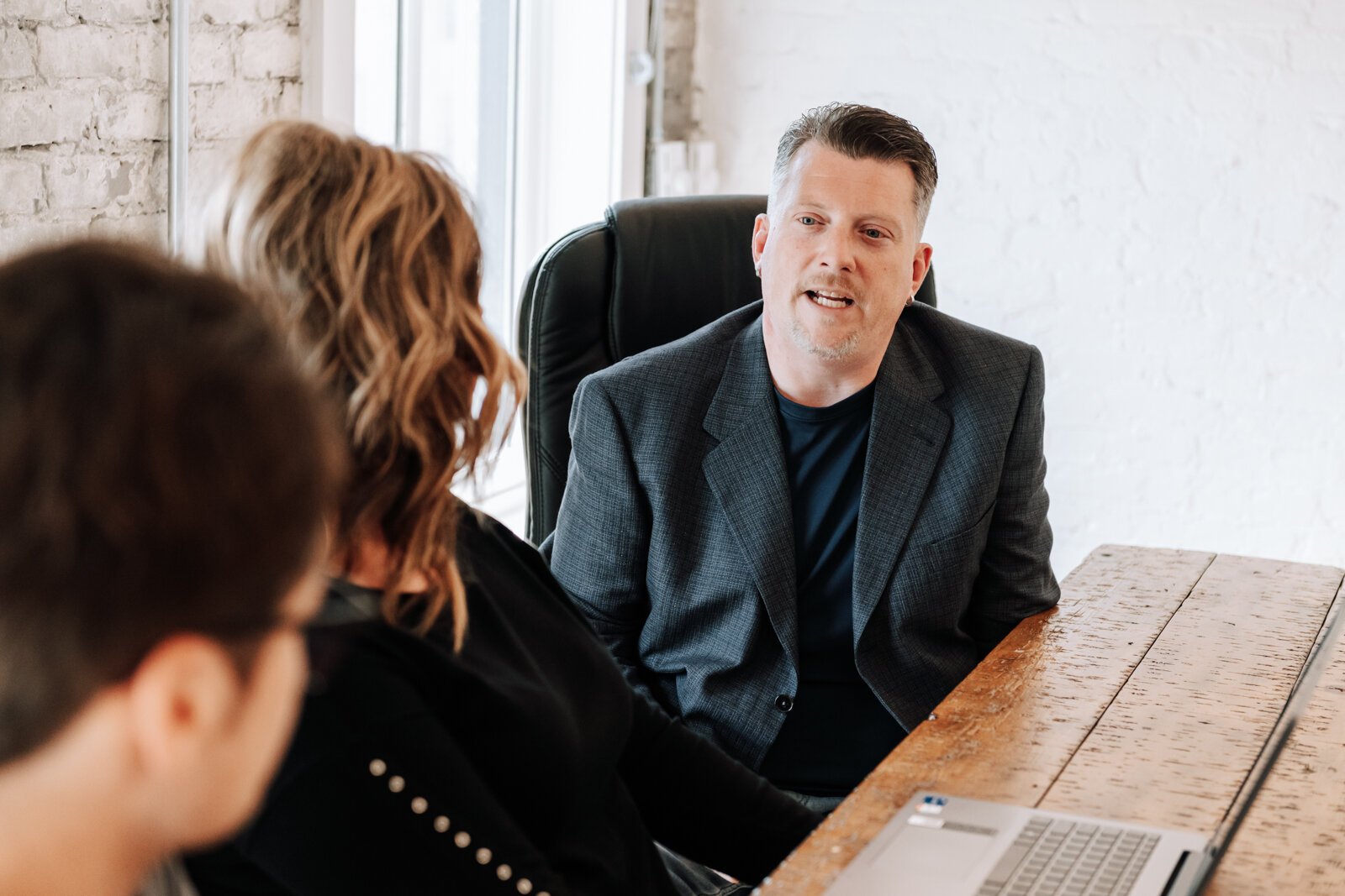 Jeremy Winters, Account Executive speaks to other team members during a meeting at 3BG SUPPLY CO.