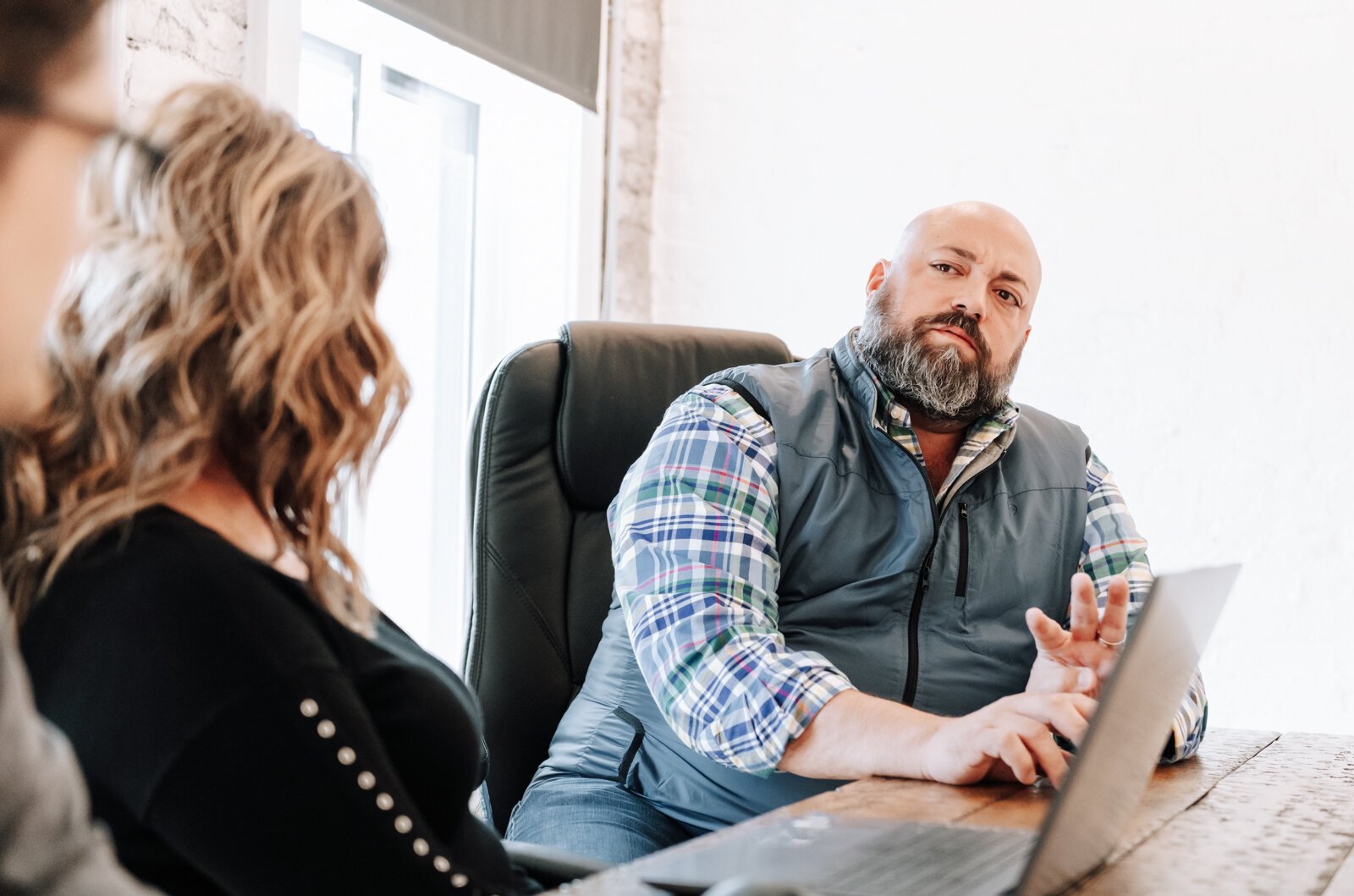 Shane Araujo, President/Co-Founder of 3BG SUPPLY CO. talks with team members during a meeting.