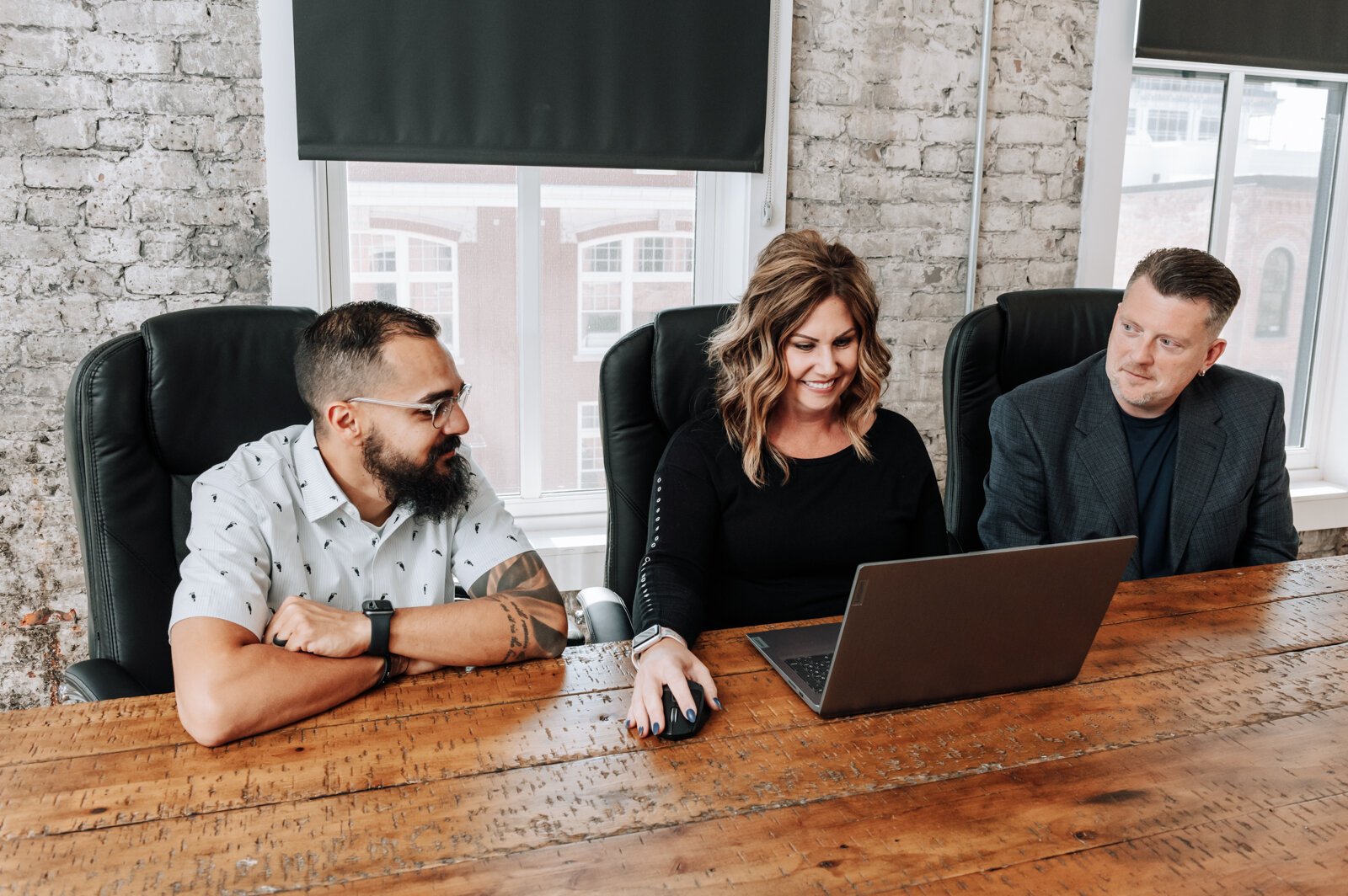 Team members from left: Jason Mullins, Sarah Winling, and Jeremy Winters work together.