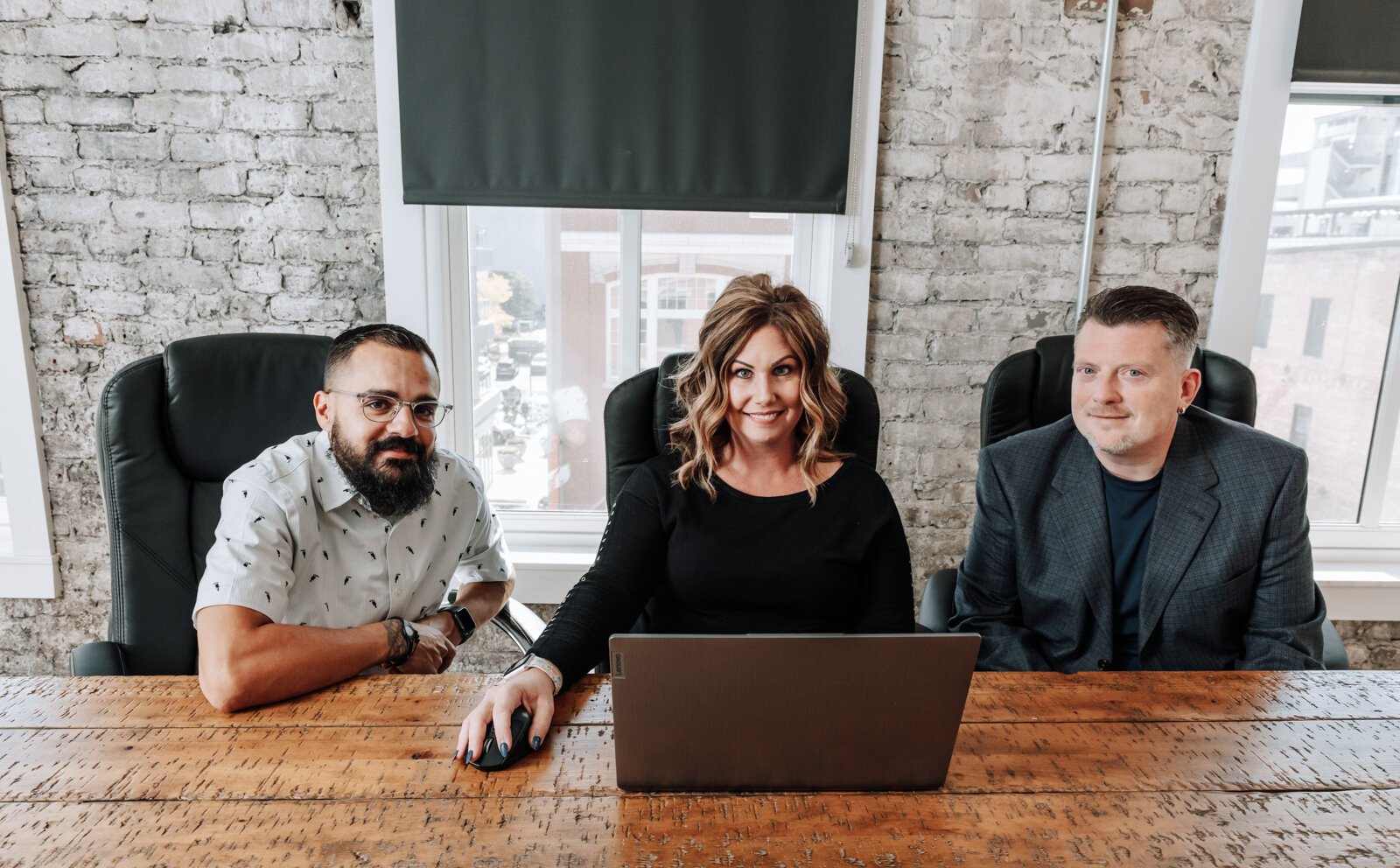 Team members from left: Jason Mullins, Sarah Winling, and Jeremy Winters work together.