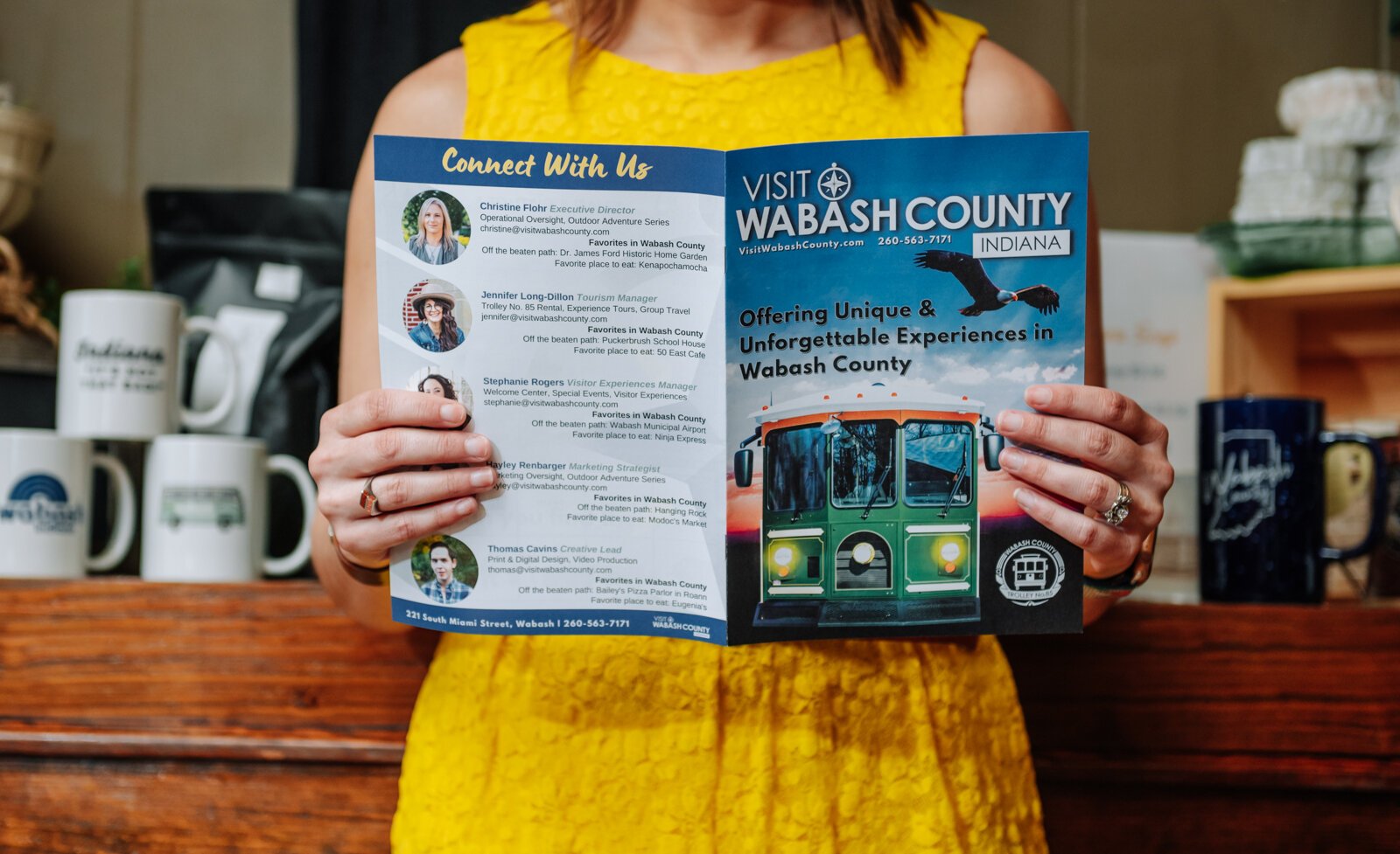 Christine Flohr, Executive Director at Visit Wabash County, holds up a visitor's guide at The Welcome Center.