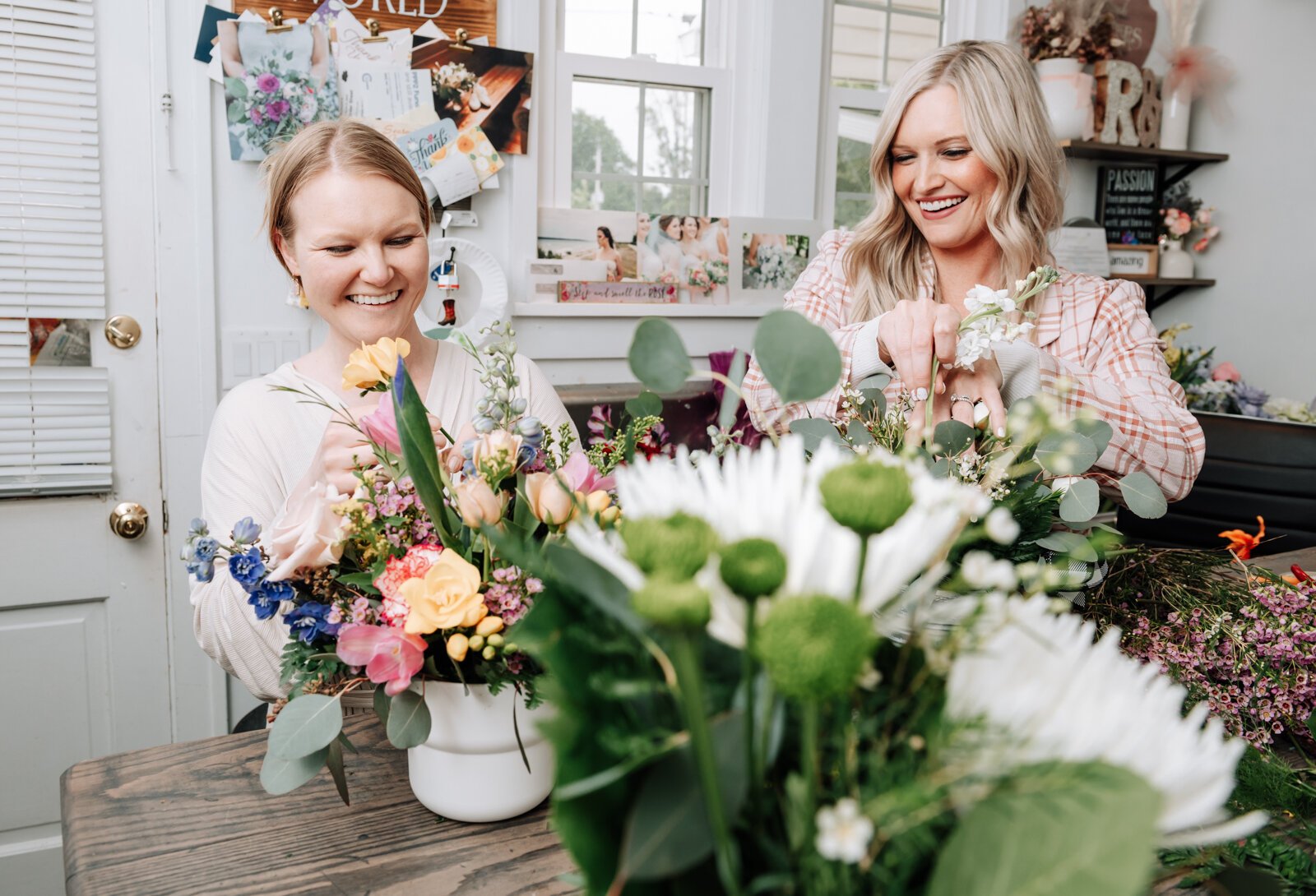 Owners Josi Cripe Lambert, left, and sister Jentri Cripe Lengerich work on creating a flower arrangement at Rhinestones and Roses Flowers and Boutique, 302 W State Rd 114.