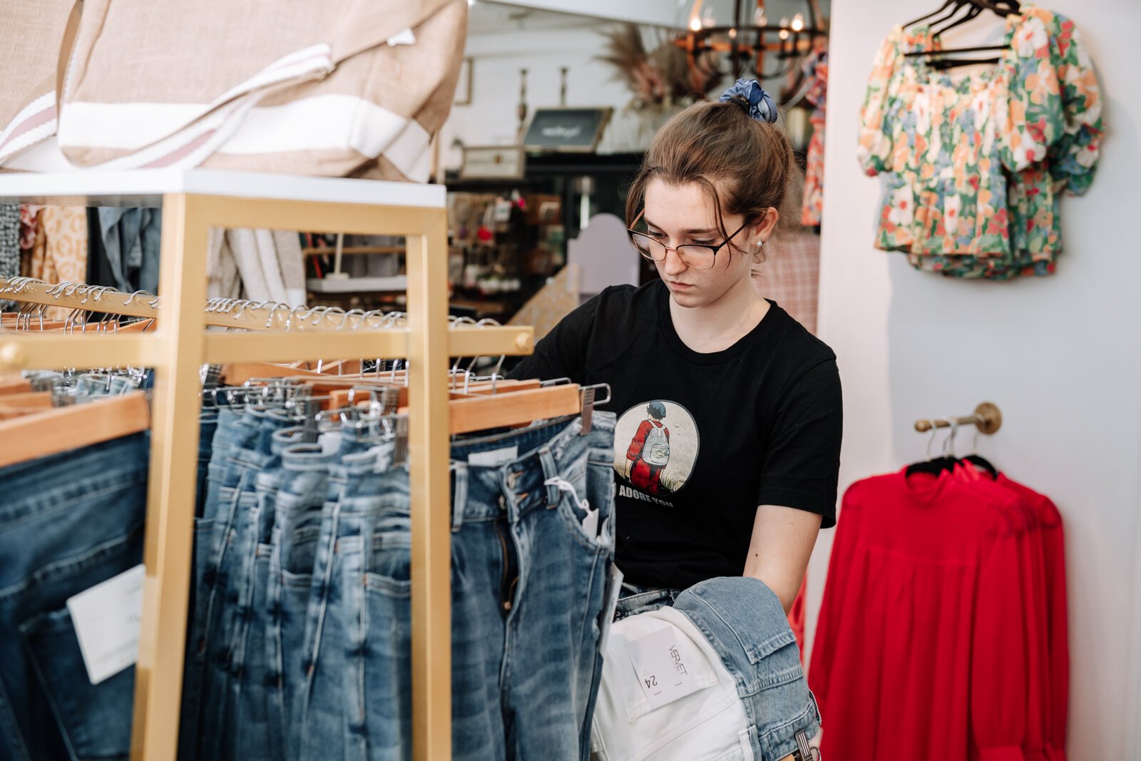 Shopper Miriam Struble-Hedstrom looks at jeans at Rhinestones and Roses Flowers and Boutique, 302 W State Rd 114, North Manchester, IN.