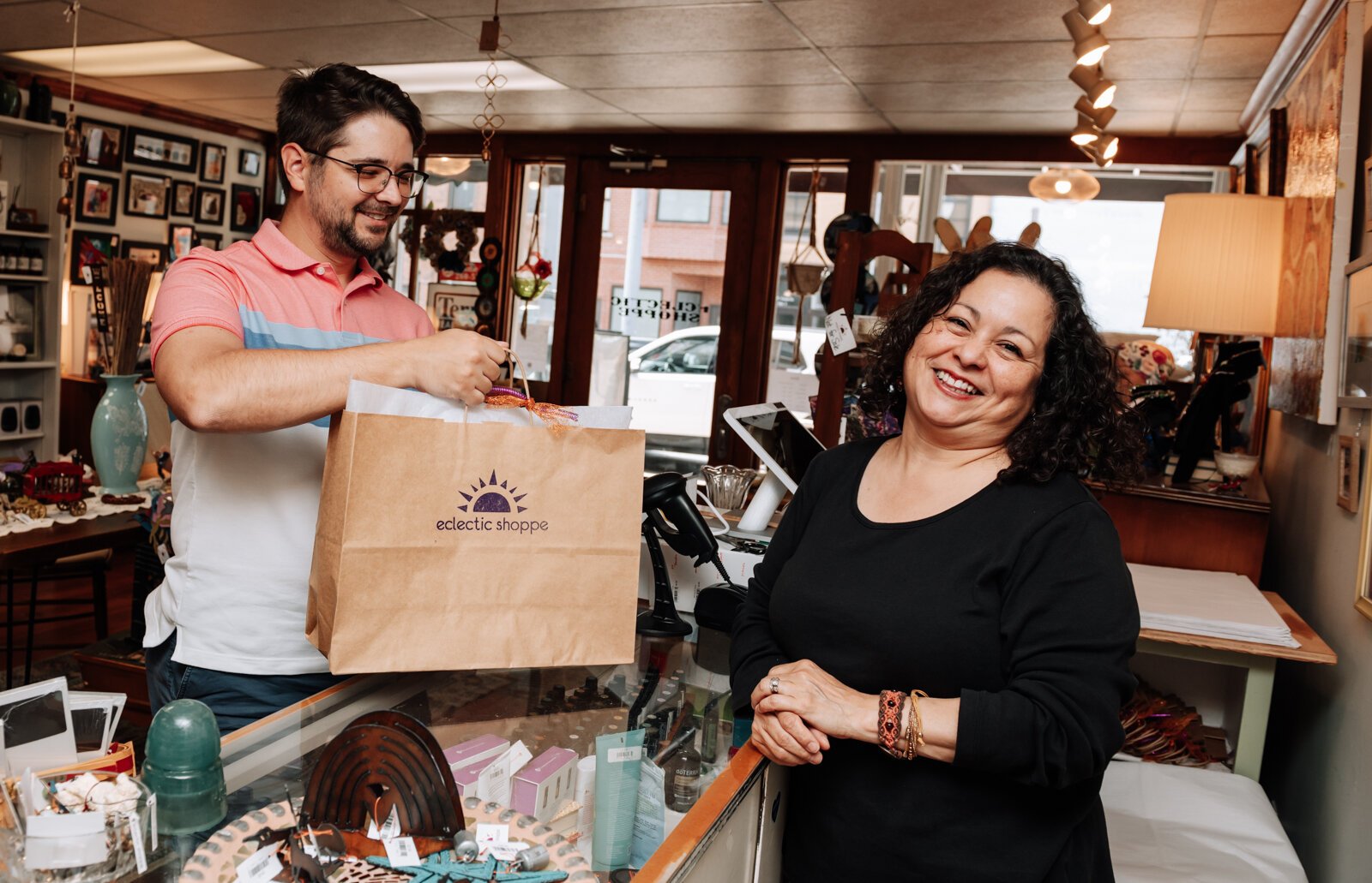 Maria Smith helps customer Mike Barnett with a purchase at Eclectic Shoppe, 42 W Canal St, Wabash, IN.