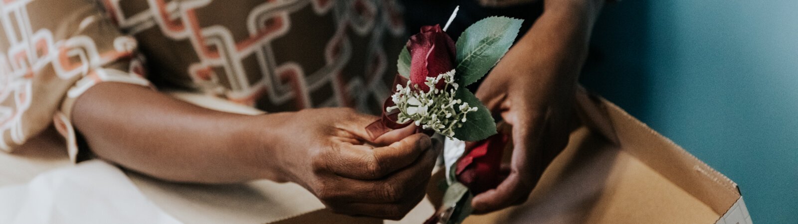 Sauntel Bennett-Totten shows off a boutineer for a client at Q'Niqque Wedding Coordinator and Event Planning.