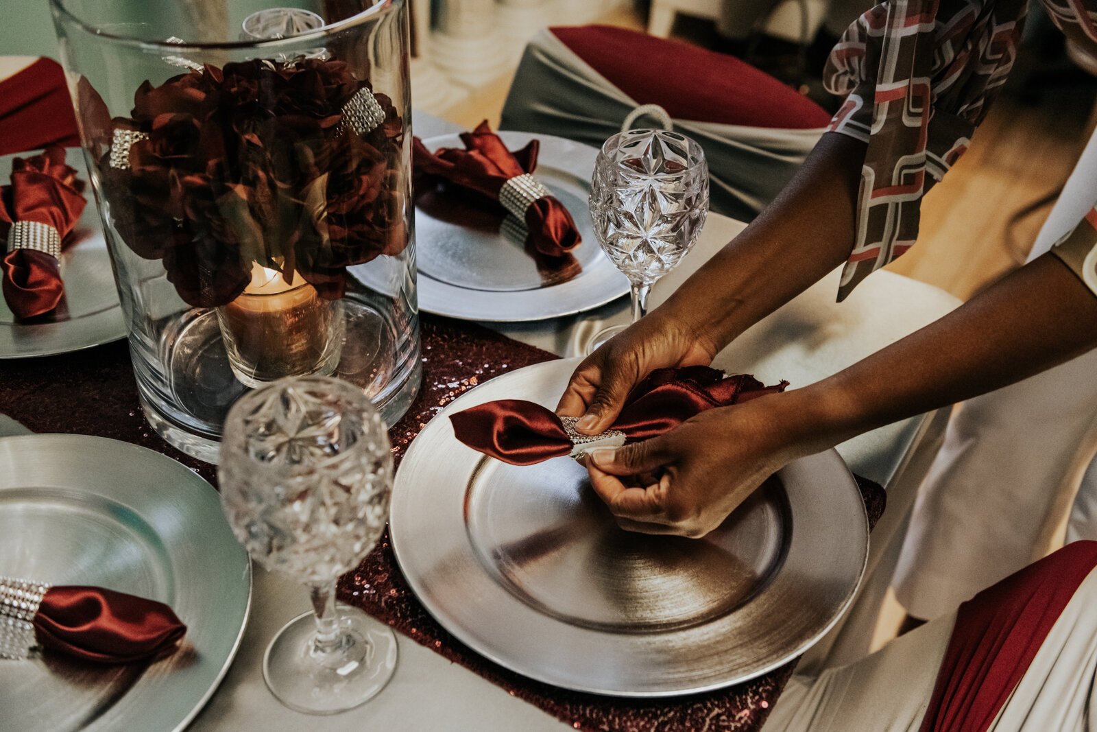 Sauntel Bennett-Totten works on creating a stylized napkin for a client at Q'Niqque Wedding Coordinator and Event Planning.