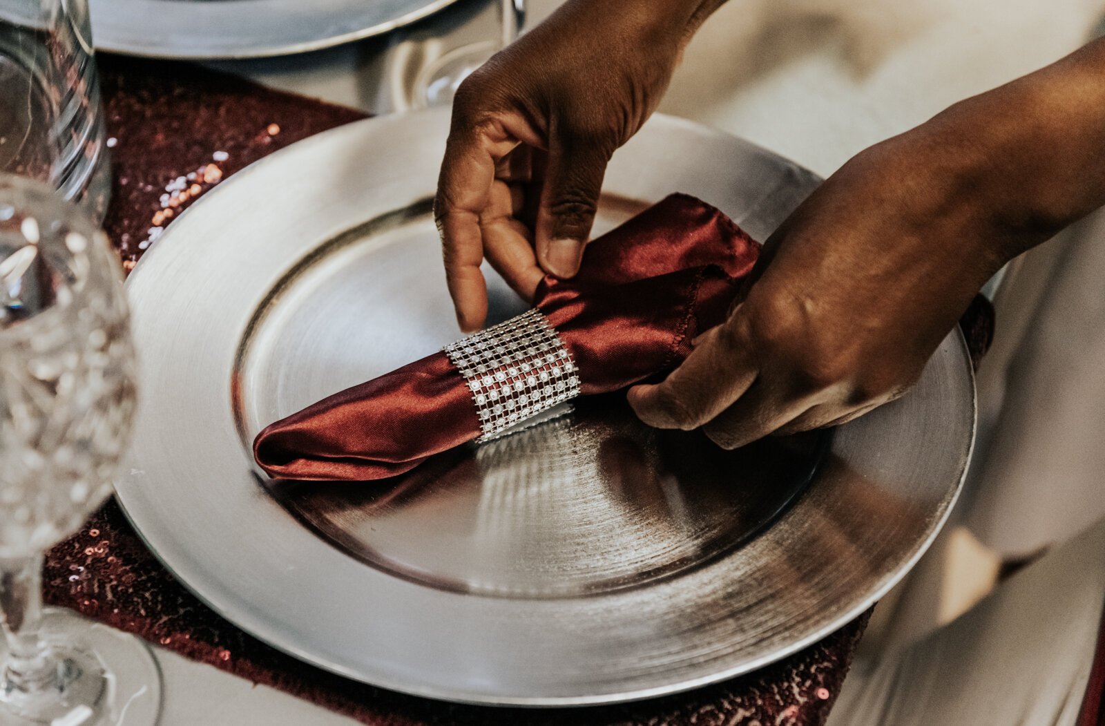 Sauntel Bennett-Totten works on creating a stylized napkin for a client at Q'Niqque Wedding Coordinator and Event Planning.