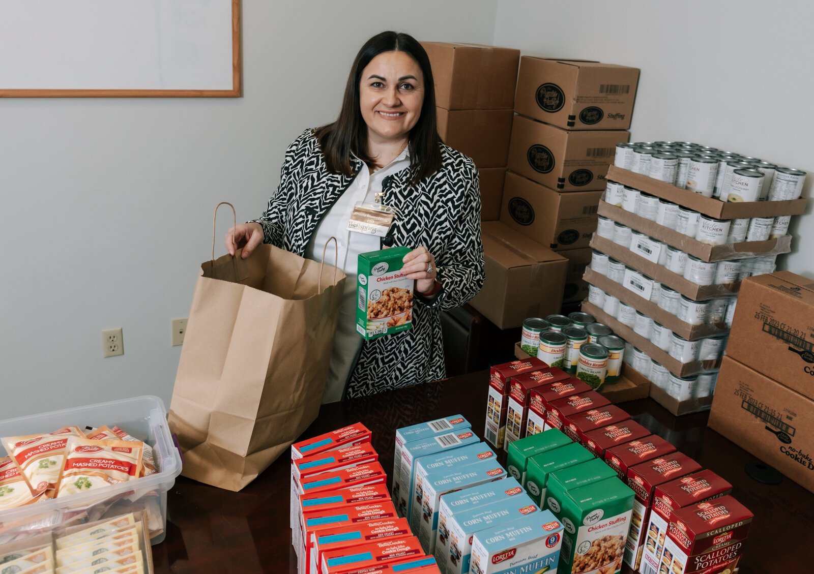 Ermina Mustedanagic, CEO of Wellspring packs a holiday bag at the foodbank at Wellspring Interfaith Social Services.