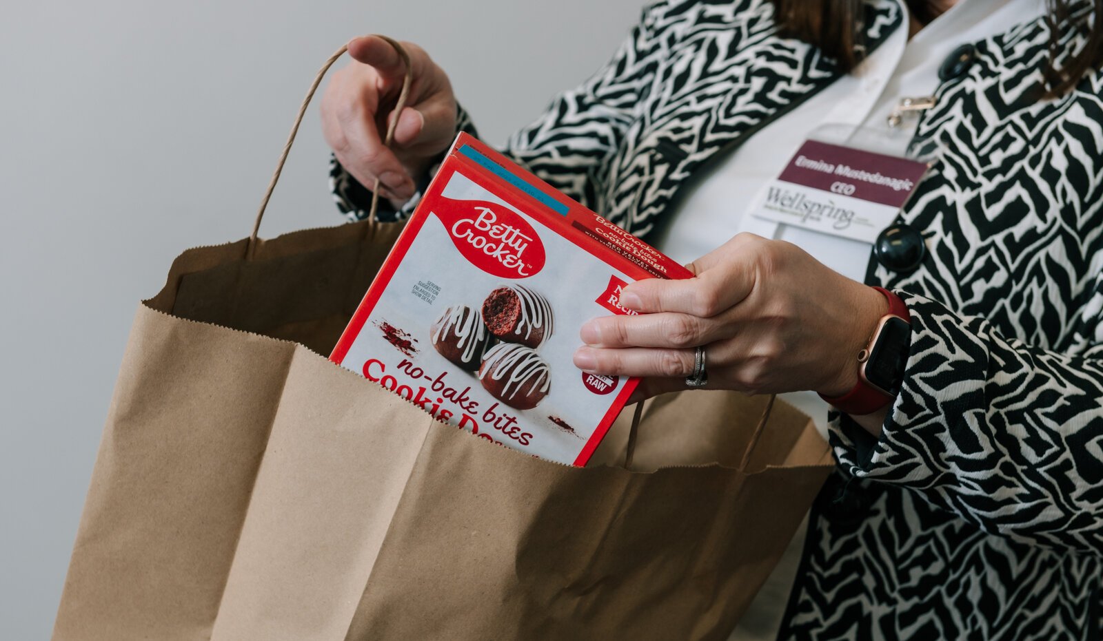 Ermina Mustedanagic, CEO of Wellspring packs a holiday bag at the foodbank at Wellspring Interfaith Social Services.