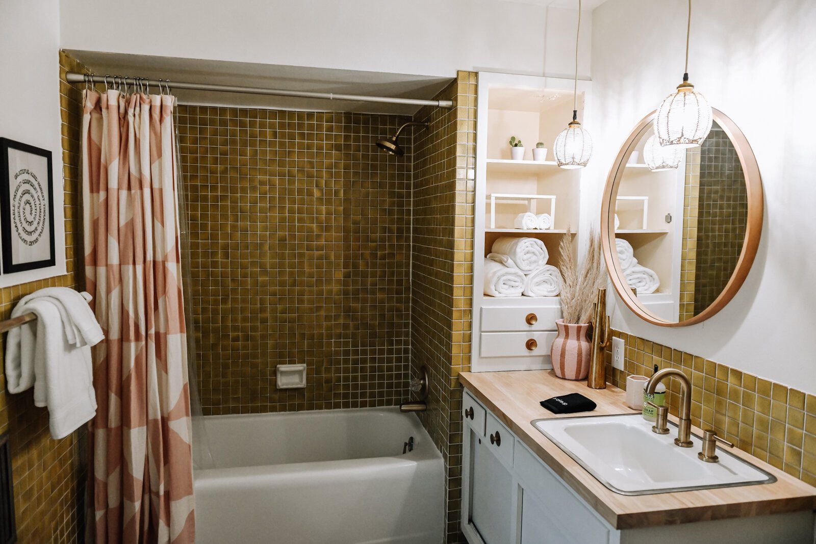 The master bathroom features a gold and pink color scheme.
