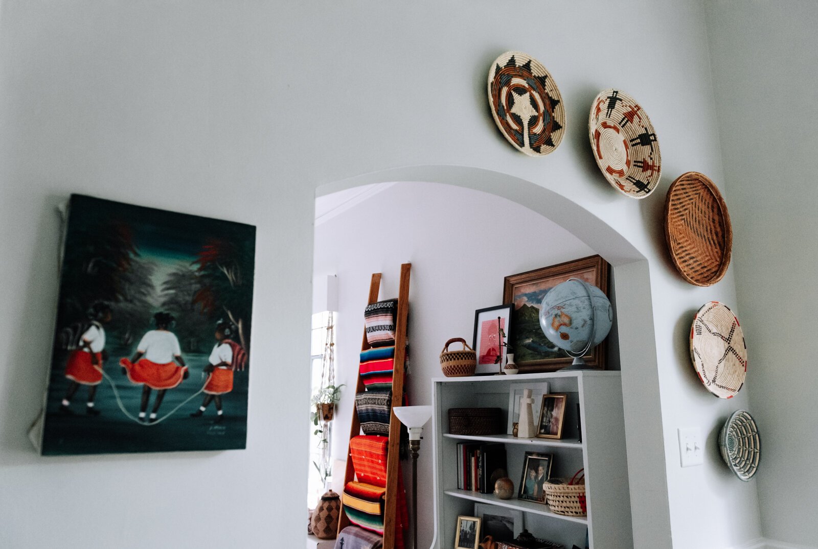 Second hand baskets decorate the dining area wall in the apartment of Jamie Curtis on Edgewater Ave.