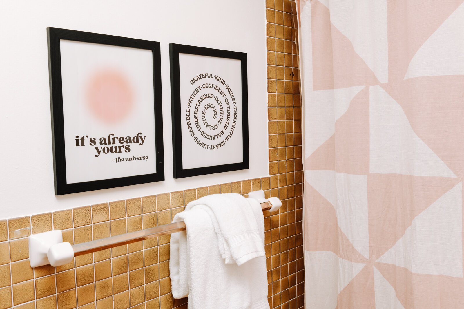 The master bathroom features a gold and pink color scheme.