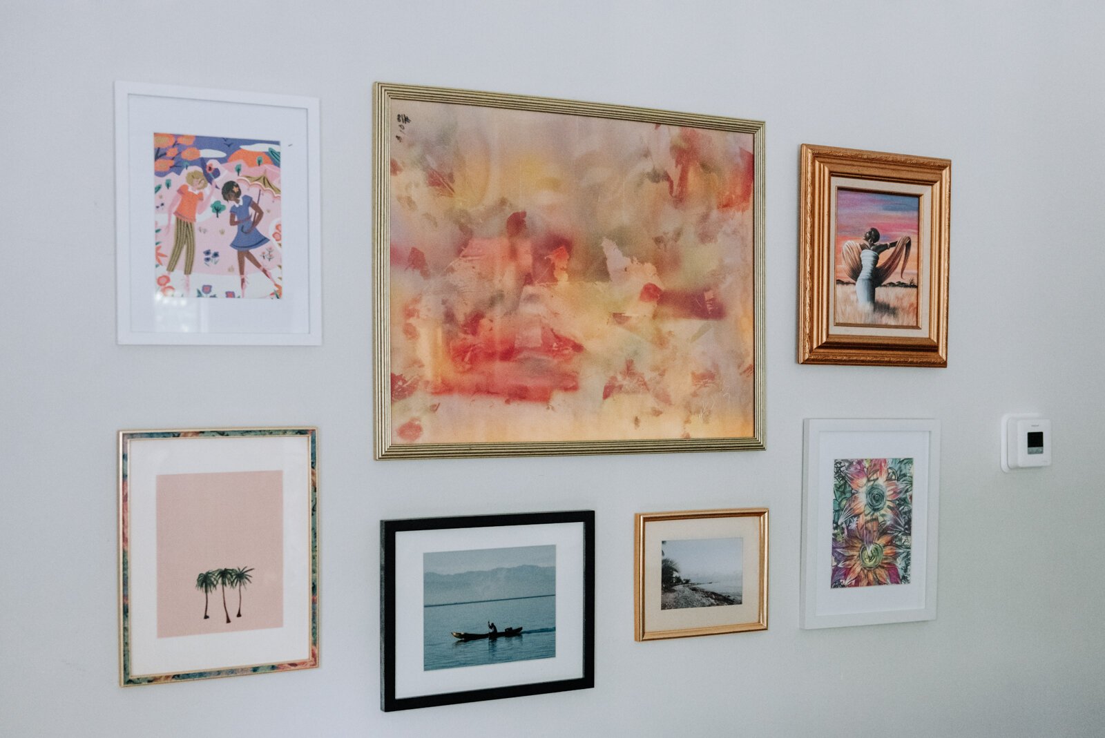 One of her favorite walls is dubbed the gallery wall and is filled with photos from travels and friends in the apartment of Jamie Curtis on Edgewater Ave.