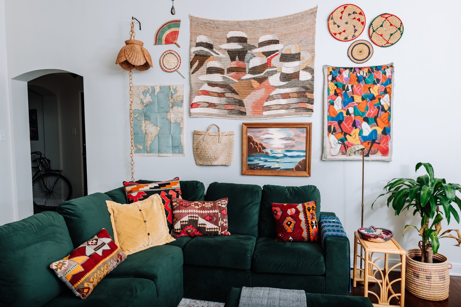 The living room features a variety of textures, artwork, gifts, and vintage items in the apartment of Jamie Curtis on Edgewater Ave. in the Lakeside Park neighborhood.