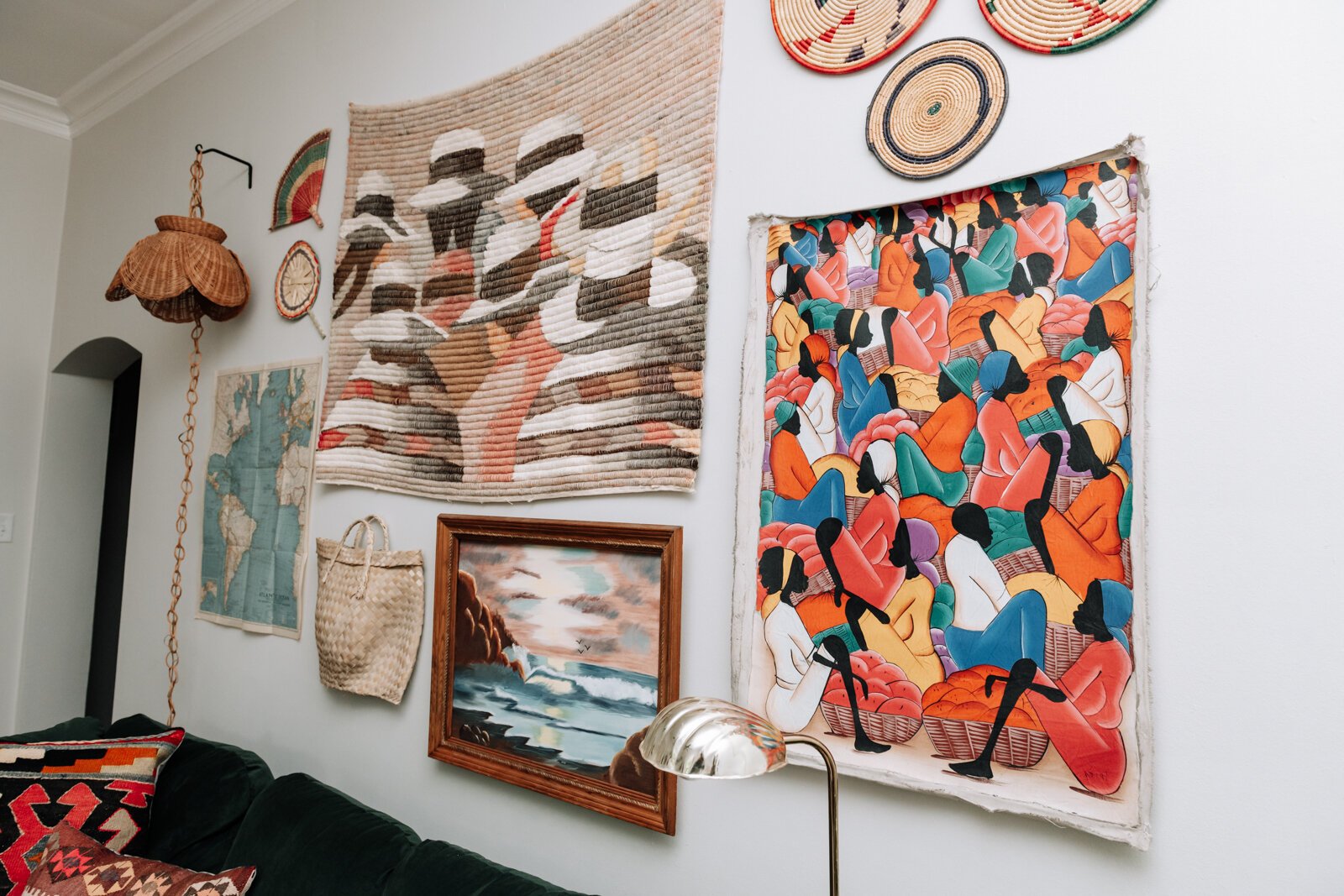 The living room features a variety of textures, artwork, gifts, and vintage items in the apartment of Jamie Curtis on Edgewater Ave. in the Lakeside Park neighborhood.