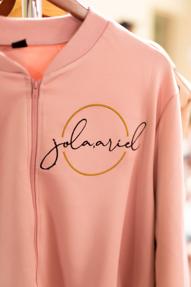 Guests shop Jordan Latham​​​​​​​'s designs for Jola Ariel Art & Boutique at a launch party in Fort Wayne.