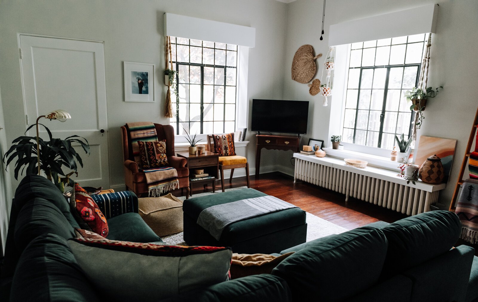 The living room features a variety of textures, artwork, gifts, and vintage items in the apartment of Jamie Curtis on Edgewater Ave. in the Lakeside Park neighborhood.