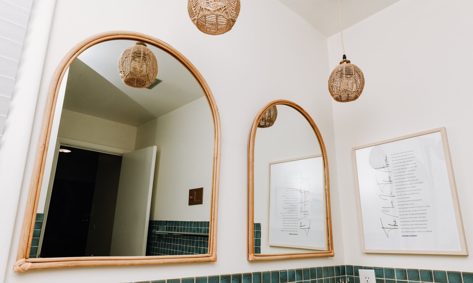 The main bathroom features gold and green tones, mirrors and original tile.