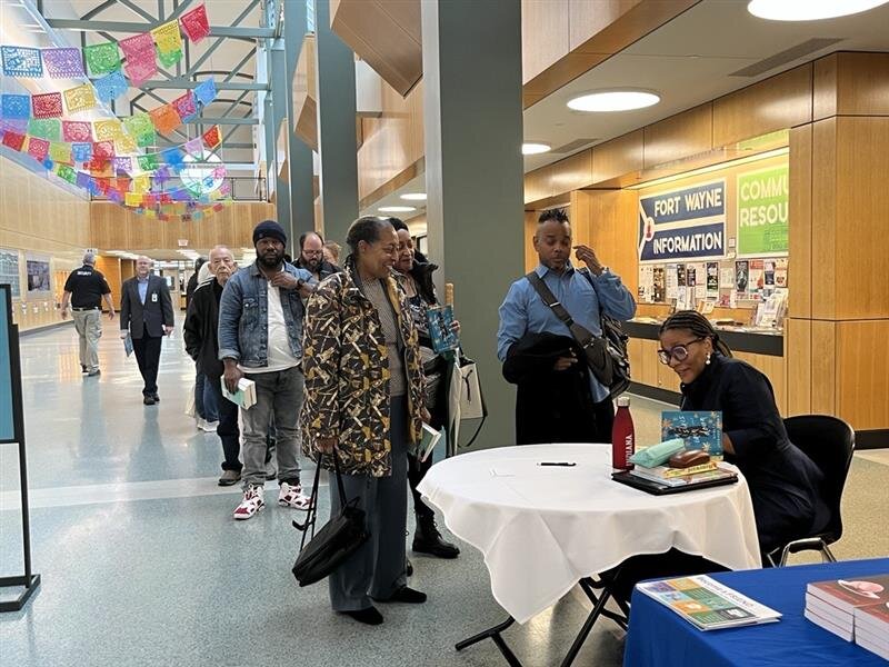 Angela Jackson-Brown signs copies of her book during  Writer’s Day with Angela Jackson-Brown at ACPL.