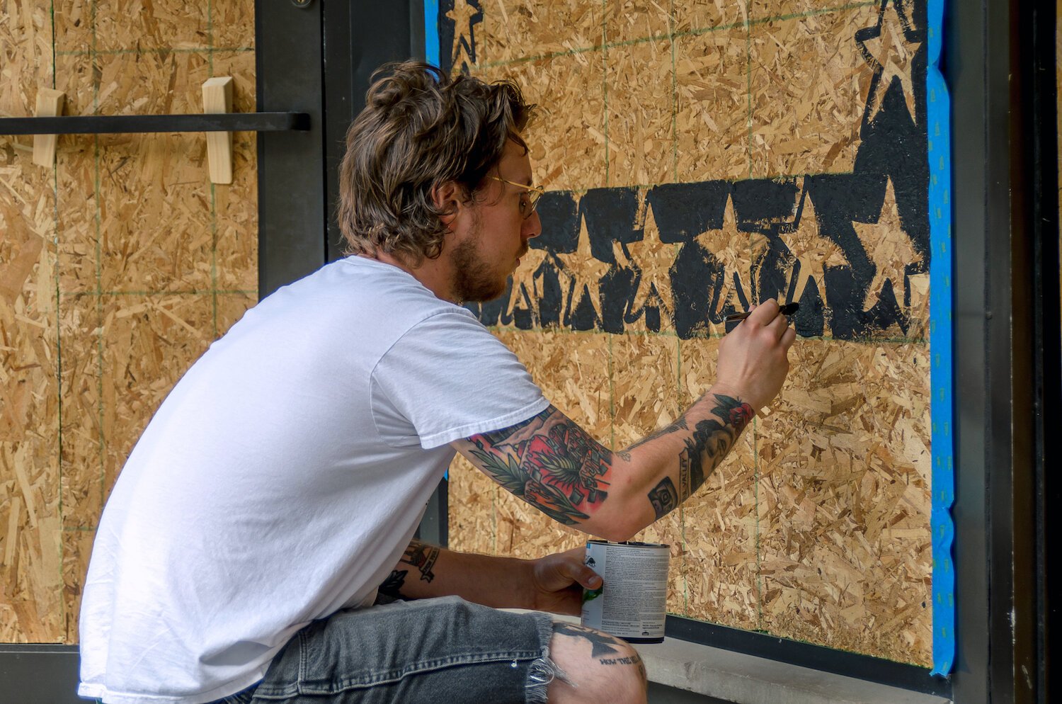 Jared Andrews paints a mural in downtown Fort Wayne.