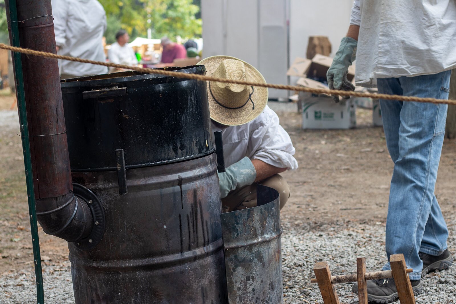 Tending to the barrells used to cook fried pickles and onions.