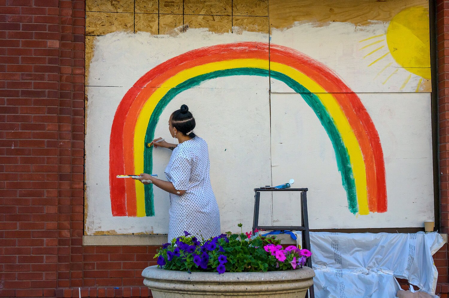 Jasmine Christensen paints a rainbow mural in downtown Fort Wayne.